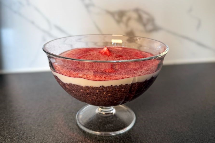 Et dessertglas med chiabudding og Healthwell Super Fruits p et bord.