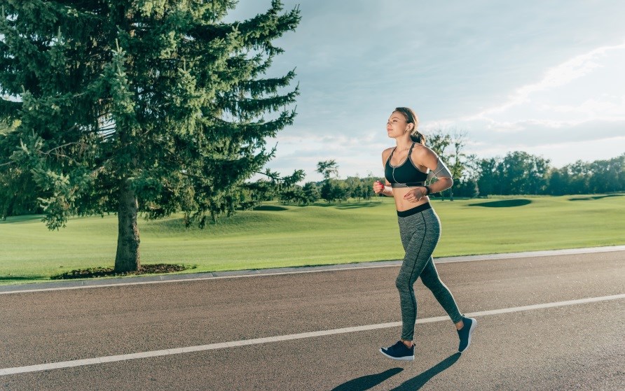 En kvinde lbetrner i naturen.