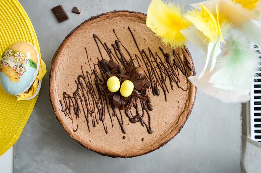 En pskekage med chokolade, omringet af pskedekorationer.